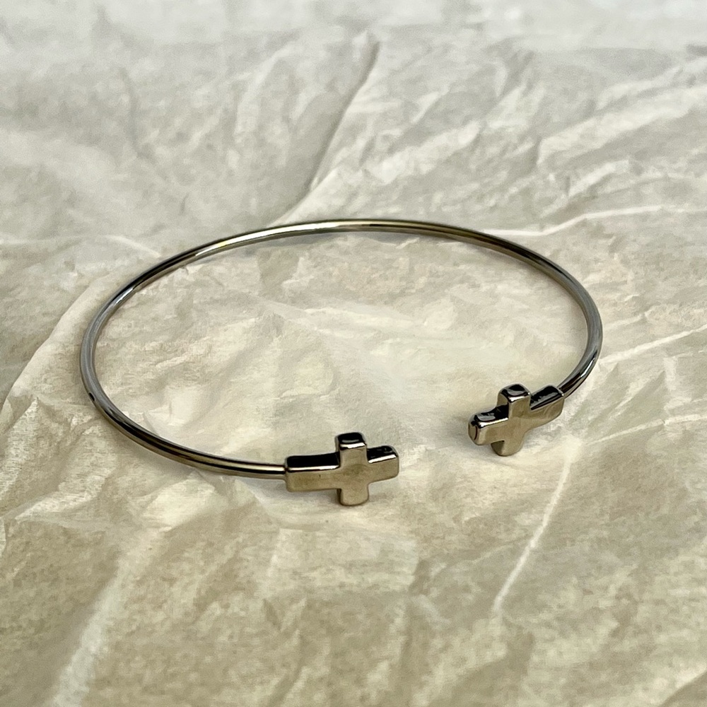 Silver tone cross open bangle bracelet. One size